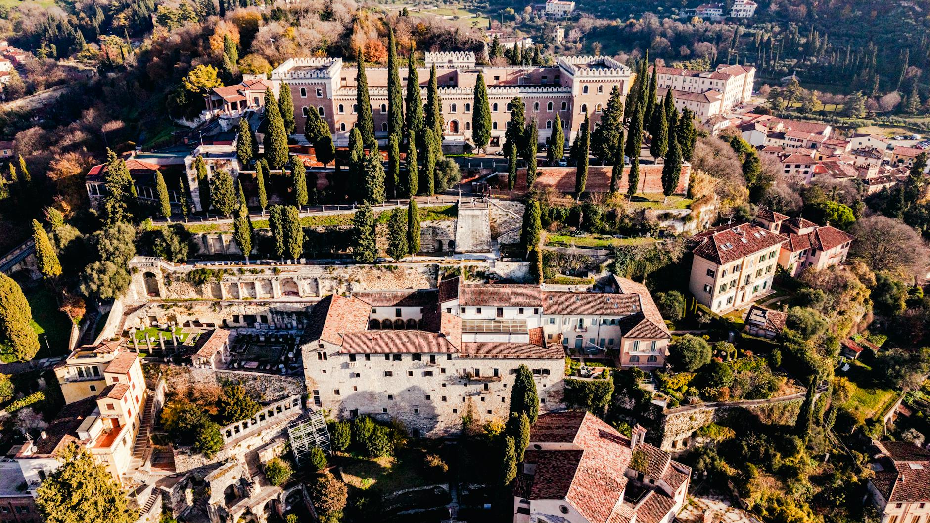 Stunning aerial view of historic castles and greenery in Verona, Italy.