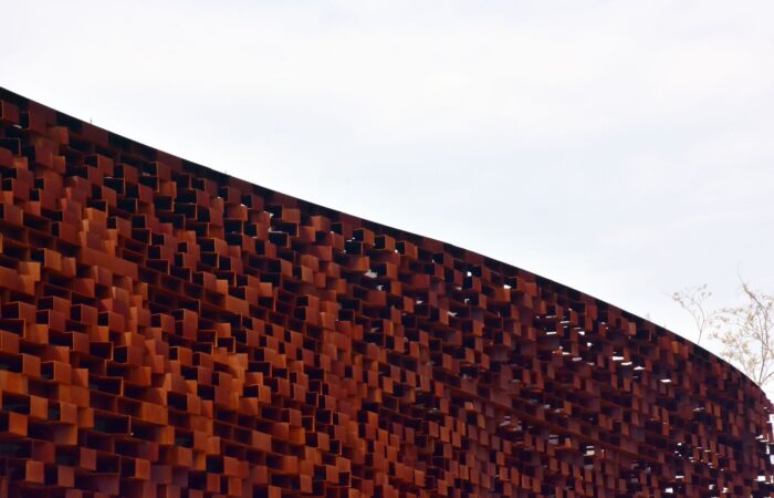 Close-up view of an abstract rusty metal structure showcasing intricate design details. Close-up view of an abstract rusty metal structure showcasing intricate design details.