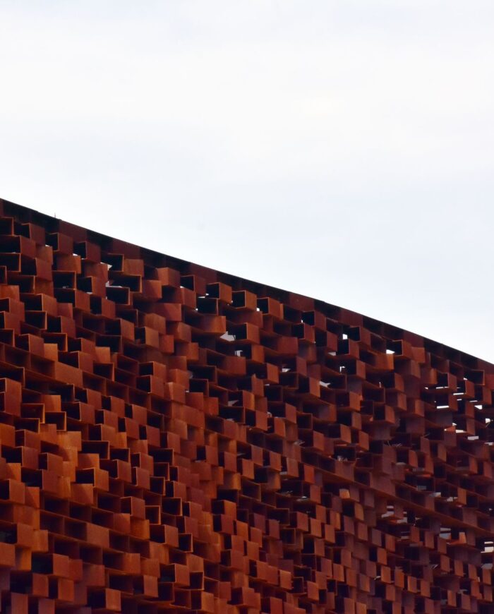 Close-up view of an abstract rusty metal structure showcasing intricate design details.