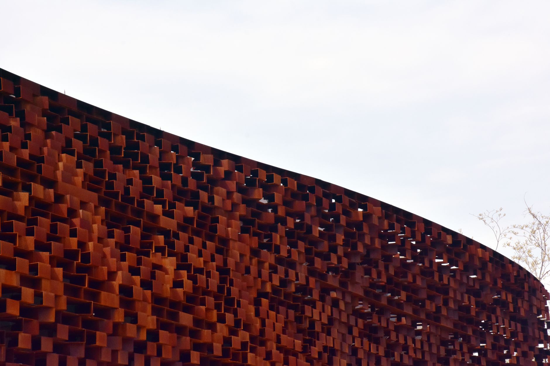 Close-up view of an abstract rusty metal structure showcasing intricate design details.