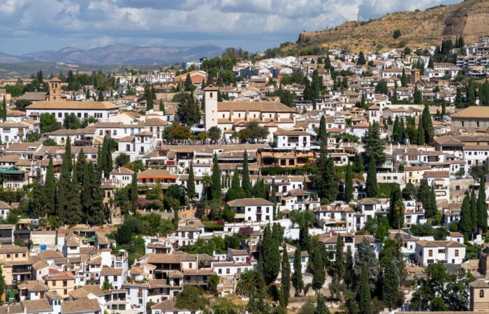 Explore Granada’s historic charm with this panoramic view of its traditional architecture set against the Sierra Nevada mountains. Explore Granada's historic charm with this panoramic view of its traditional architecture set against the Sierra Nevada mountains.