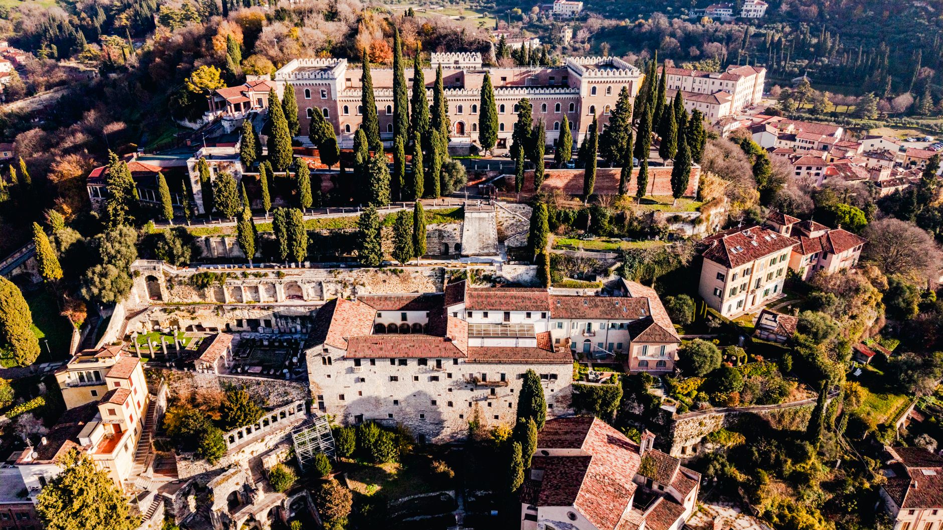 Stunning aerial view of historic castles and greenery in Verona, Italy.